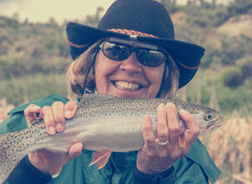 Woman holding a fish she caught Woman holding a fish she caught